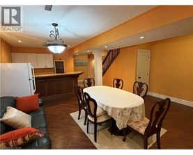 A dining room with a round table and chairs.