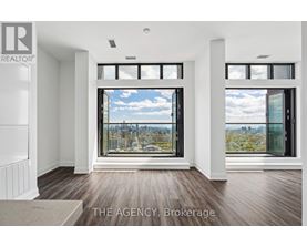A real estate agency showcases a spacious room with a view of the cityscape through large windows.