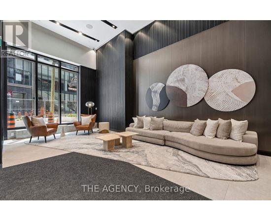 A modern living room with a large couch and a rug.