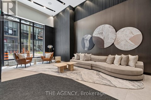 A modern living room with a large couch and a rug.