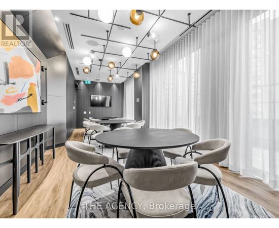 A modern dining room with a round table and chairs.