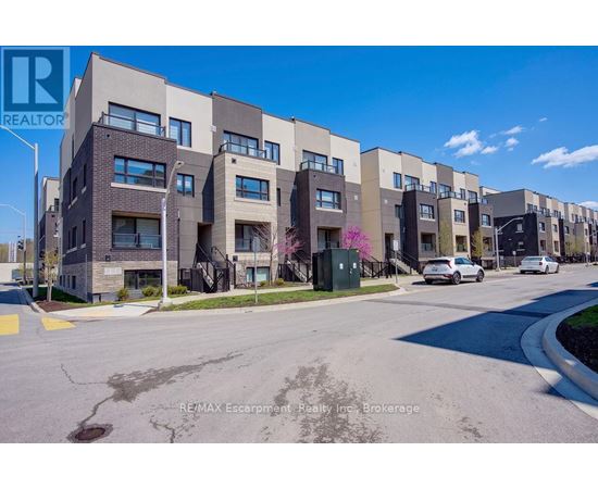 Apartment building with cars parked in front.