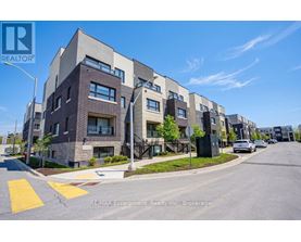 A street view of a residential area with apartment buildings and cars parked on the side of the road.
