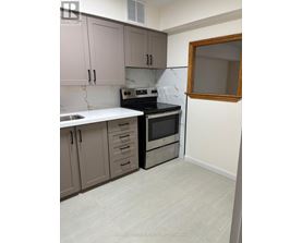 A kitchen with a white countertop and a black oven.