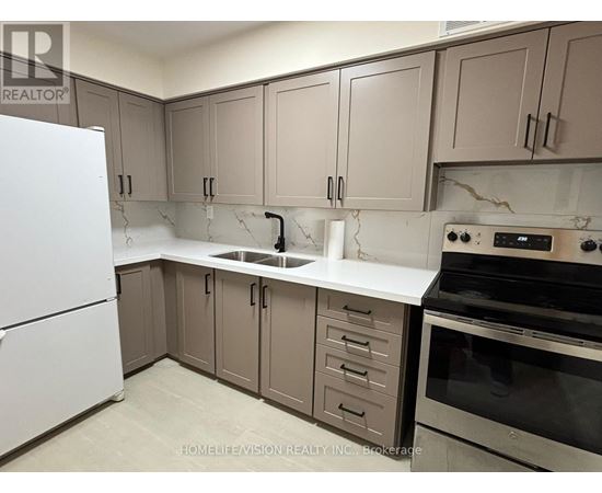 A kitchen with a white fridge, brown cabinets, and a black stove top oven.