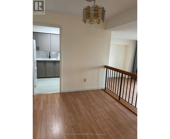 A room with wooden flooring and a chandelier.