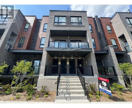A multi-story apartment building with a "For Sale" sign in front.