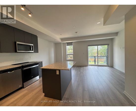 A kitchen with dark wood cabinets and stainless steel appliances.