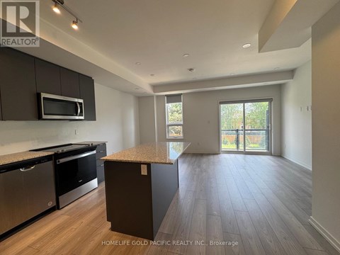 A kitchen with dark wood cabinets and stainless steel appliances.