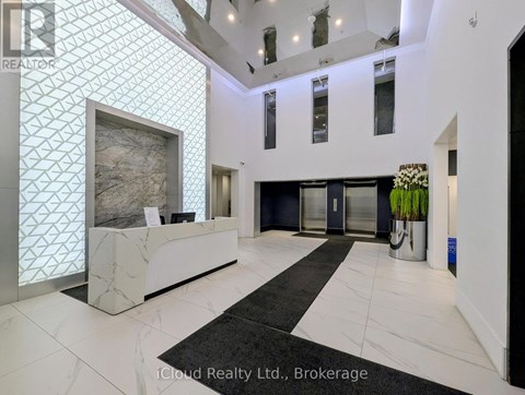 A reception area with a marble counter and a large painting on the wall.
