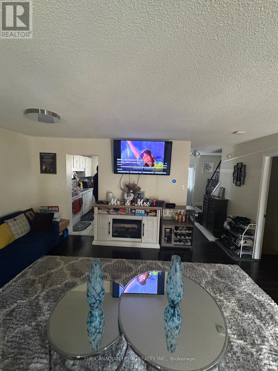 A living room with a television and a couch.