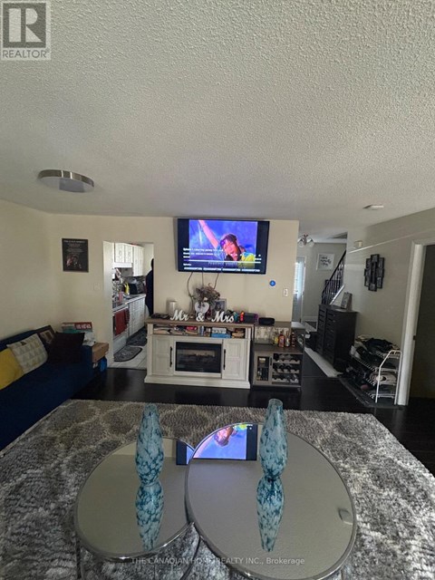 A living room with a television and a couch.