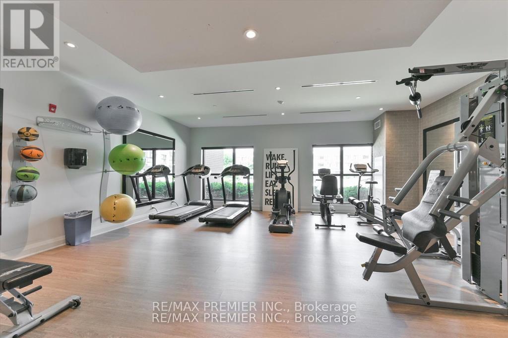 A gym with a variety of equipment including treadmills, weights, and exercise balls.