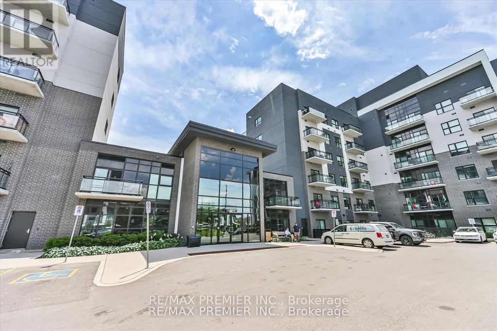 A modern multi-story residential building with cars parked in front.