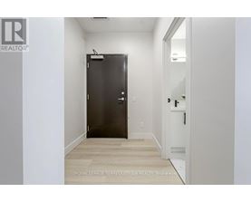 A room with a door and a wall with a logo.