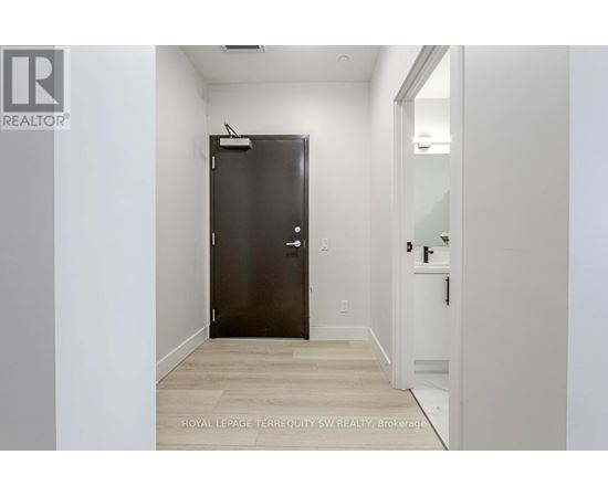 A room with a door and a wall with a logo.
