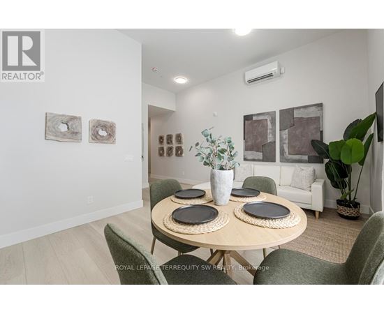 A dining room with a table set for four and a green chair.