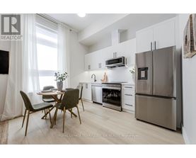 A kitchen with a table and chairs in front of a window.