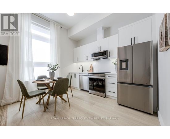 A kitchen with a table and chairs in front of a window.