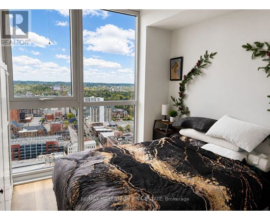 A bedroom with a large bed and a view of the city.