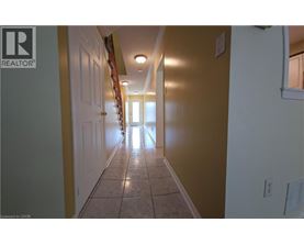 A hallway with tiled floors and white walls.