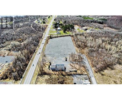 An aerial view of a real estate brokerage office surrounded by trees.