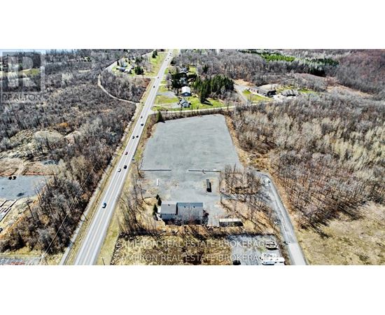 An aerial view of a real estate brokerage office surrounded by trees.