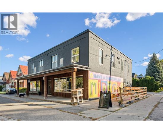 A grey building with a sign that says "Have a Murgi" in front of it.