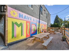 A colorful mural on a building with the word "MIDDLE" in the center.