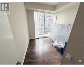 A room with a window and a bed in it.