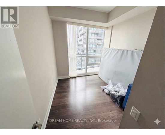 A room with a window and a bed in it.