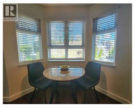 A dining room with a table and chairs.