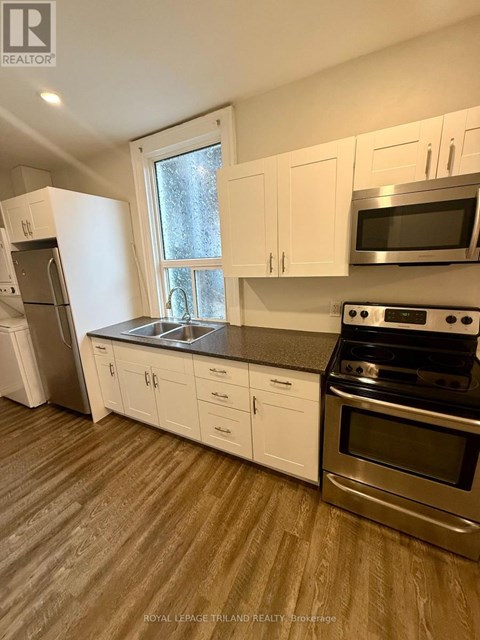 A kitchen with white cabinets and stainless steel appliances.