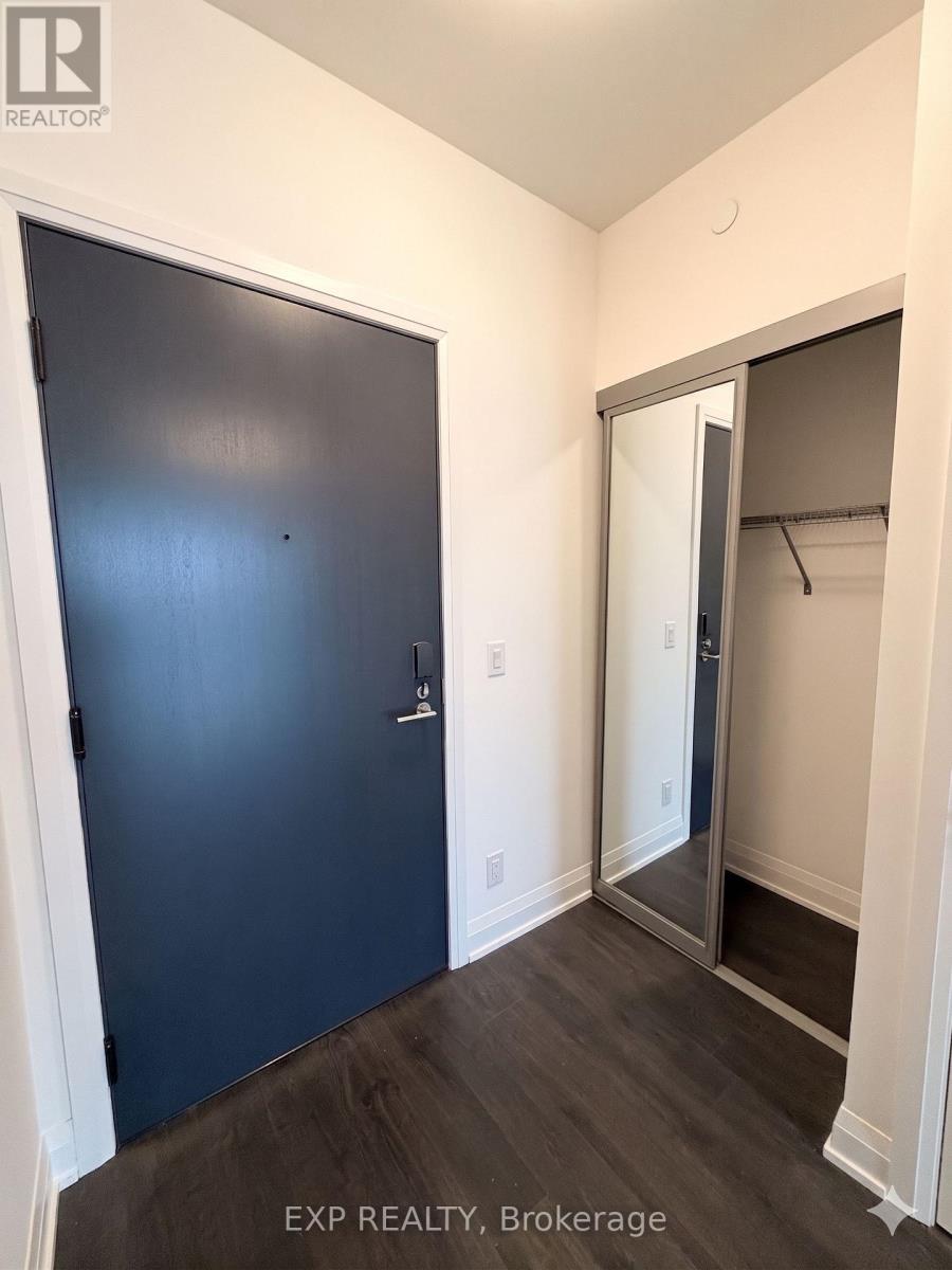A room with a blue door and a white wall.