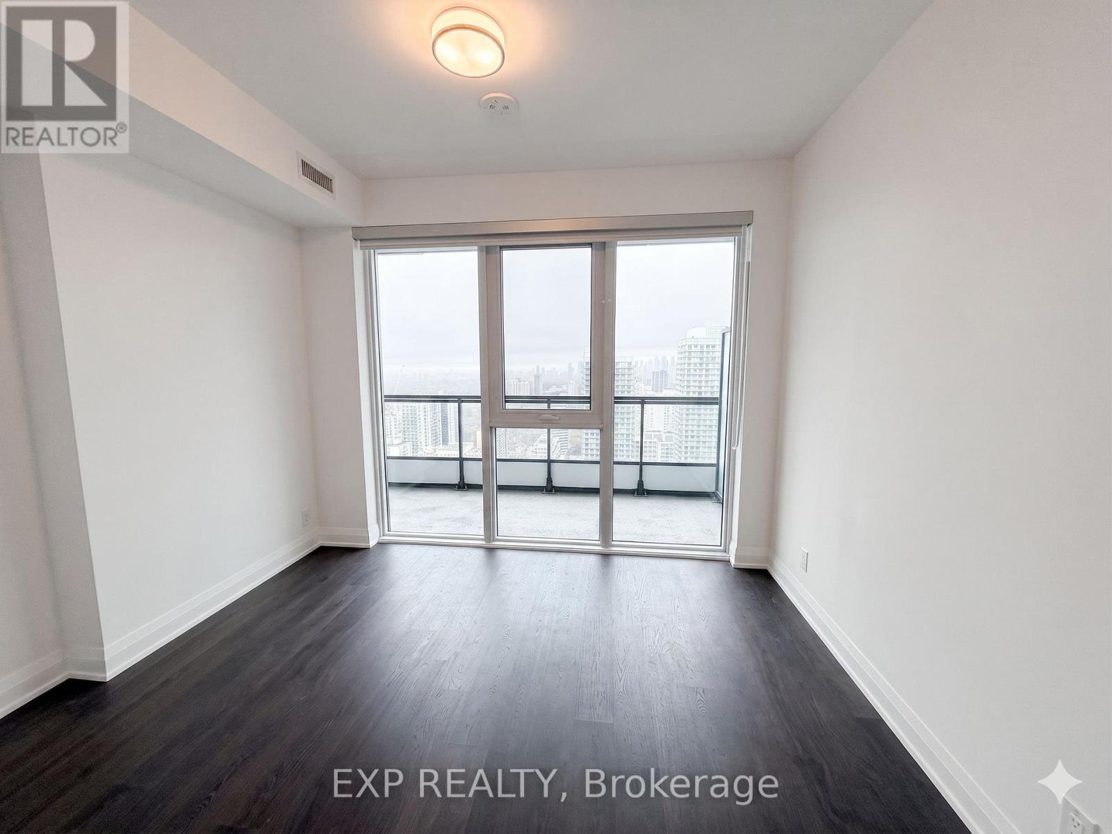 A room with EXP REALTY, Brokerage written on the floor.