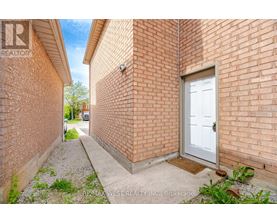 A white door is on the brick wall of a building.