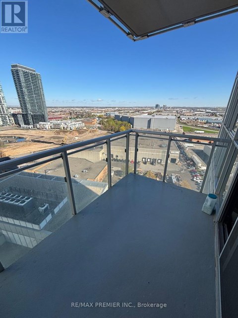 A view from a balcony overlooking a cityscape.