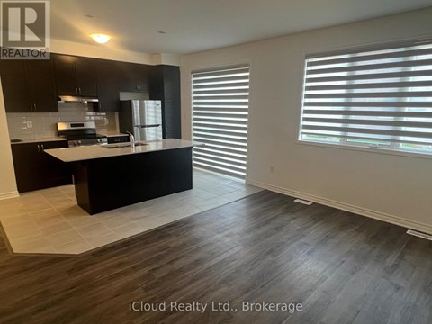 A kitchen with black cabinets and a white countertop.