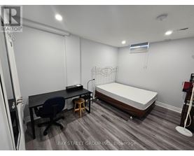 A room with a bed, desk, and chair.