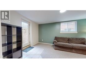 A living room with a couch and a bookshelf.