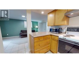 A kitchen with a stove top oven and microwave.