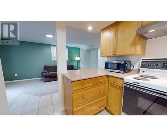 A kitchen with a stove top oven and microwave.