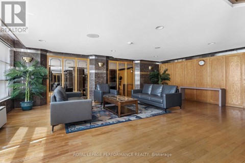 A living room with a grey couch and a wooden floor.