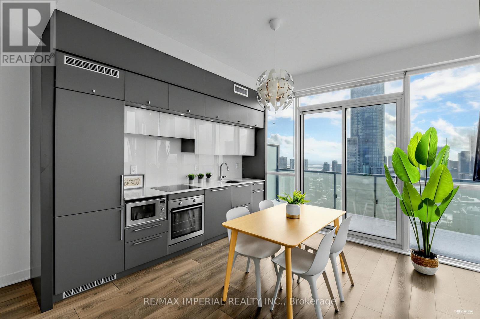 A modern kitchen with a dining table and chairs.
