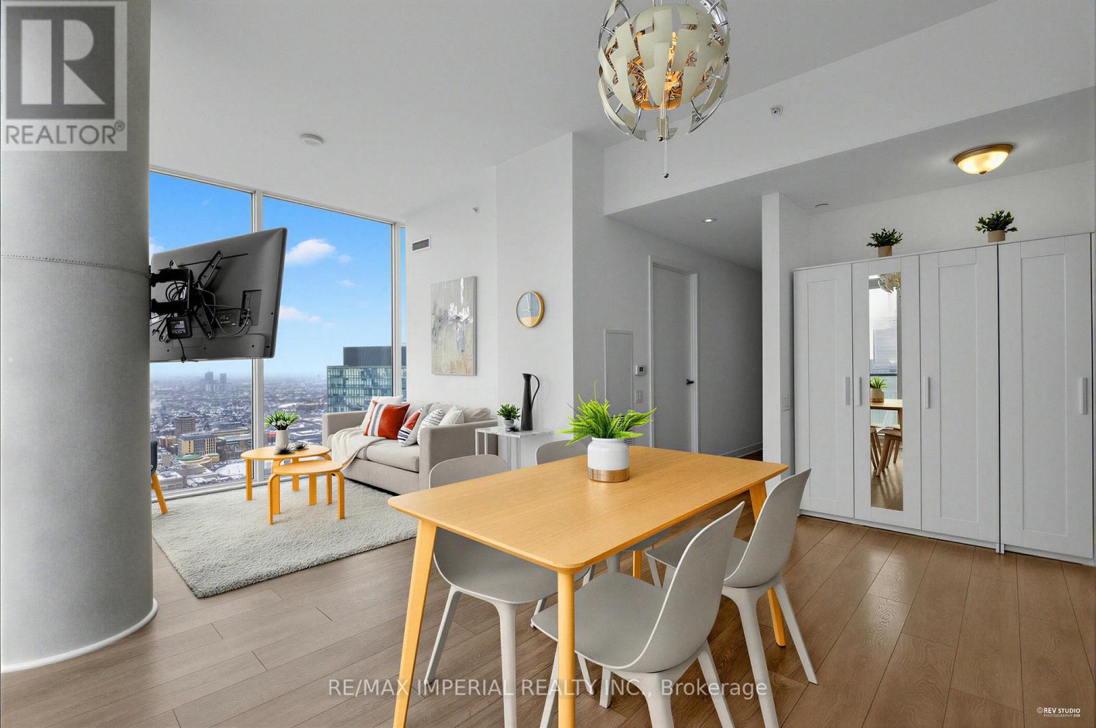 A modern dining room with a wooden table and chairs.