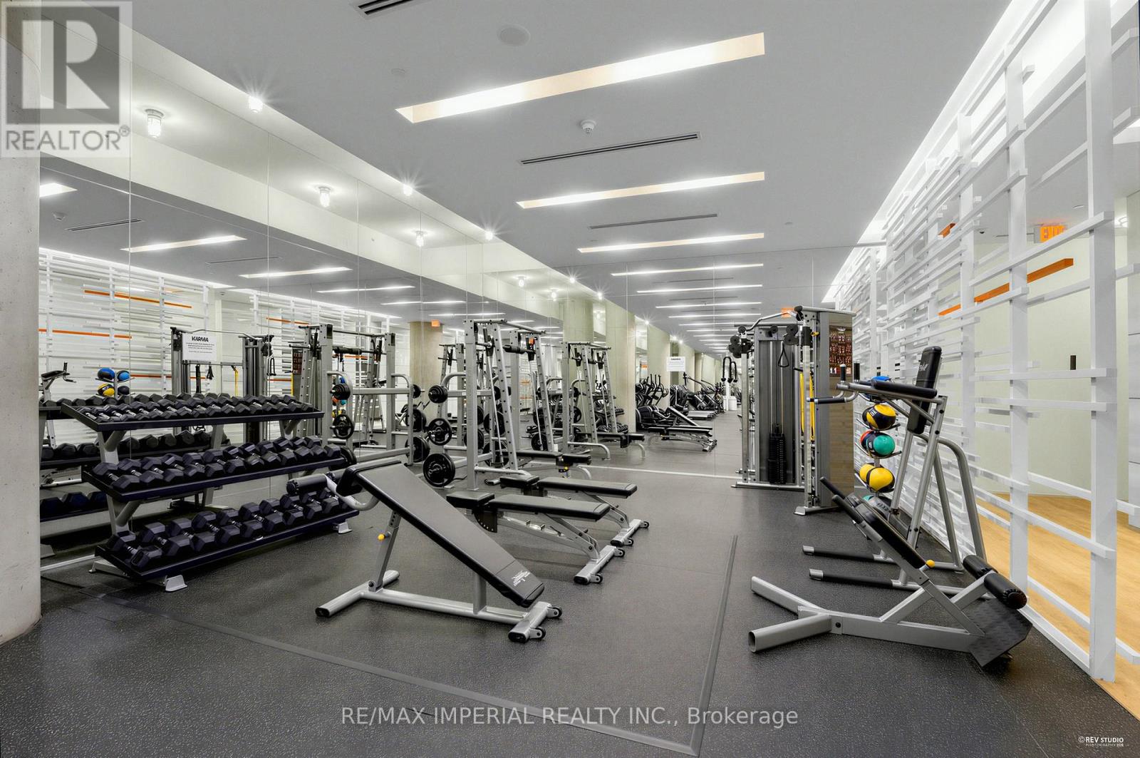 A gym with a variety of equipment including weights and cardio machines.
