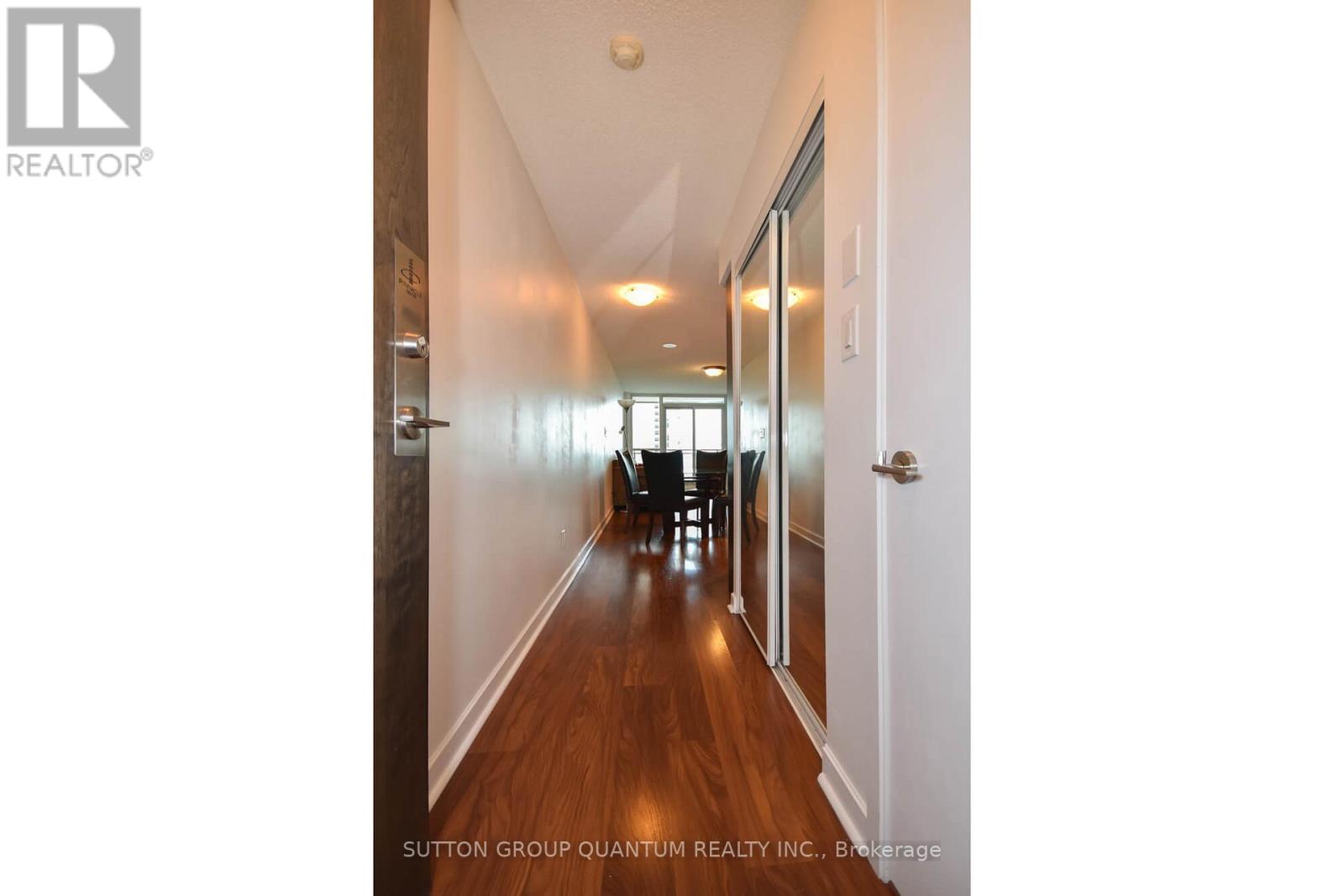 A hallway with doors on both sides and a light on the ceiling.