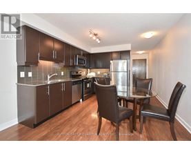 A kitchen with brown cabinets and a glass table.