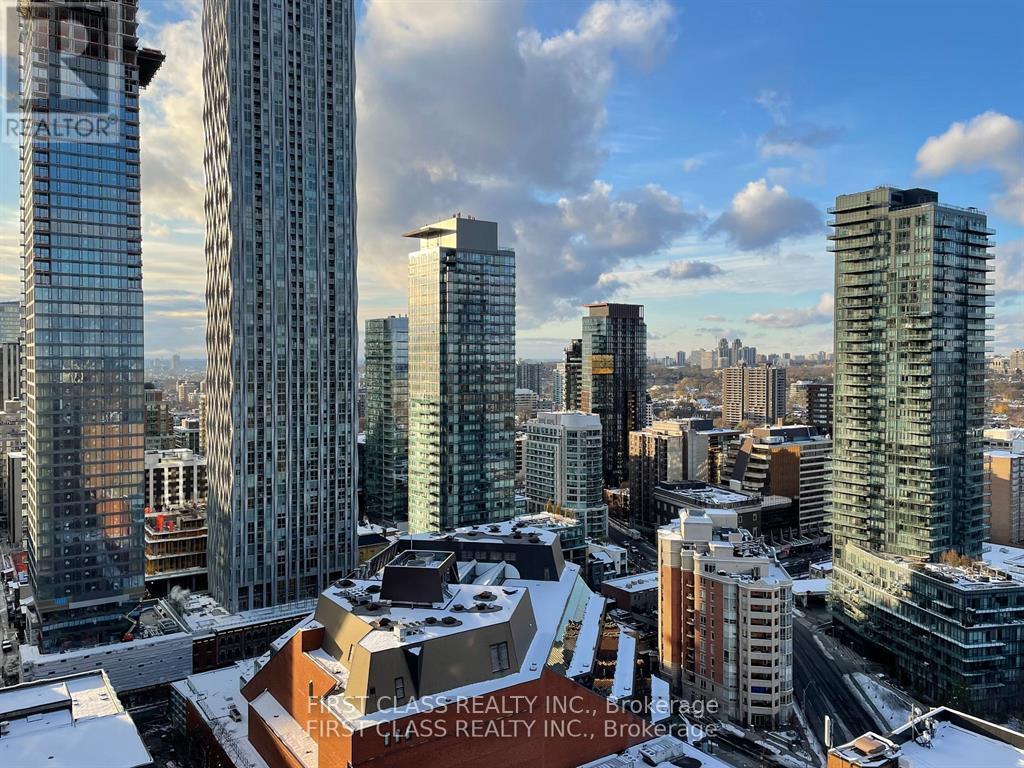 A cityscape with First Class Realty Inc. buildings in the foreground.