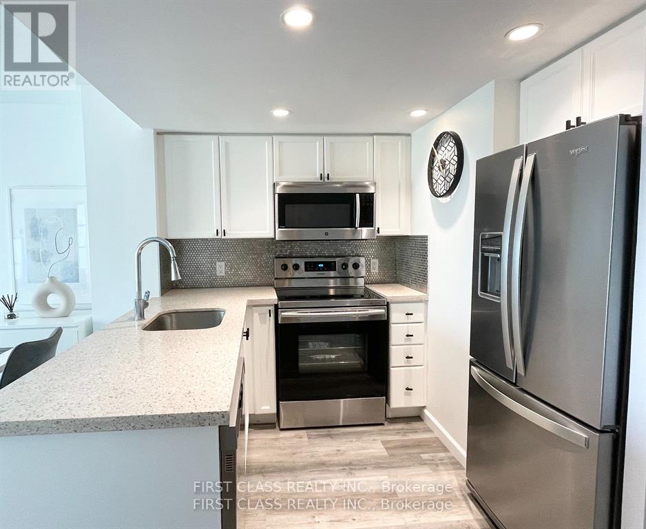 A modern kitchen with a refrigerator on the right.